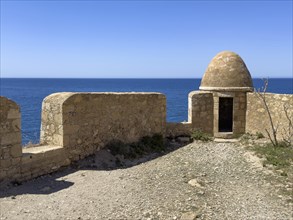 Round watchtower and wall with crenellated gap for guns one of 10 round watchtowers of historic