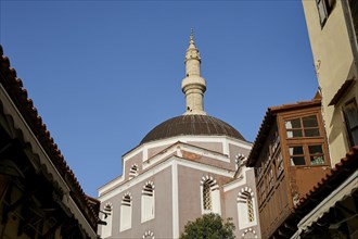 Suleiman Mosque, minaret and dome of a mosque, surrounded by historic buildings under a blue sky,