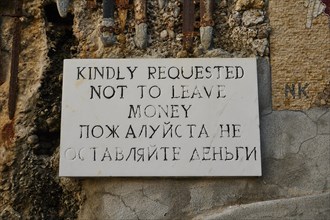 Rock Chapel, Archangel Michael Panormitits, A sign with the request not to leave money, in English