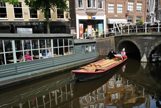 A load of Beemster cheese being transported on a canal in the city centre on market day., Alkmaar,