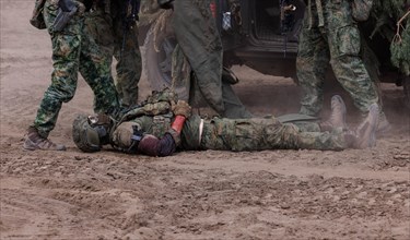 Dutch soldiers care for a simulated injured comrade as part of the NATO large-scale manoeuvre
