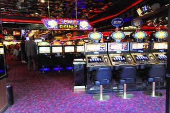 Las Vegas, Nevada, USA, North America, Row of slot machines in a colourfully lit casino, Las Vegas