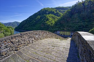 The historic Ponte della Maddalena bridge over the River Serchio in Garfagnana, Borgo a Mozzano,