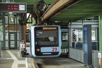 The Wuppertal suspension railway at Vohwinkel station waits for departure while the electronic