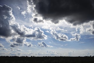 A dark cumulus cloud looms menacingly over the landscape