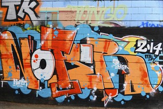 Barcelona, Catalonia, Spain, Europe, Graffiti with large, colourful lettering on a wall in an urban
