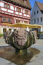 Fountain with inscription Gemmingen, stone grapes, water features, Ratsstueble restaurant at the