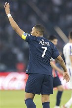 Football match, captain Kylian MBAPPE' Paris St Germain raises his left arm upwards and looking