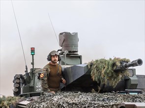 A soldier stands on a Cougar infantry fighting vehicle, taken during the NATO Steadfast Defender