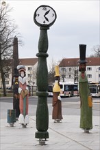 Travellers from another time, wooden sculptures on the station forecourt, Neustrelitz,