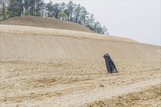 Black corrugated pipes protruding out of ground at rural construction site in Daejeon, South Korea,