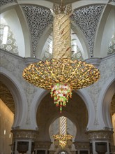 An ornate interior with large arches and a magnificent chandelier that creates a harmonious