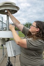 Dearborn, Michigan, Rebecca Robak, an environmental technician, checks air quality instruments at a
