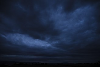 A bad weather front moves in, dark clouds in the night