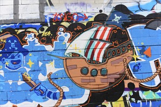 Barcelona, Catalonia, Spain, Europe, Imaginative graffiti of a cartoon ship with bright colours on