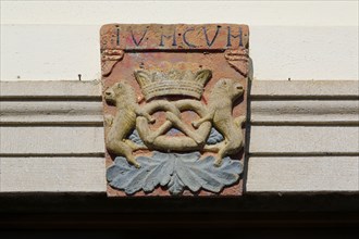 Stone plaque with pretzel on facade, Adler am Schloss, hotel, inn, restaurant, lettering, detail,