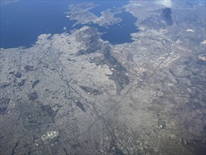 Aerial view from high altitude Overview of the city of Athens, bottom left in the picture Olympic
