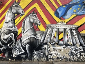 Street art shows the Brandenburg Tor with horses on the outer wall of the German Embassy in Buenos