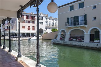 Townscape with restaurants at the Pont principal du port grimaud, Port Grimaud, Var,