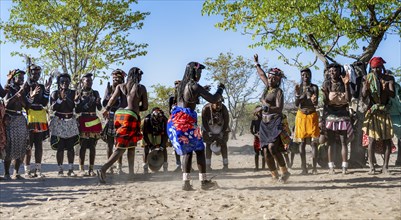 Group of traditional Hakaona woman and men, dancing and clapping, Angolan tribe of the Hakaona,