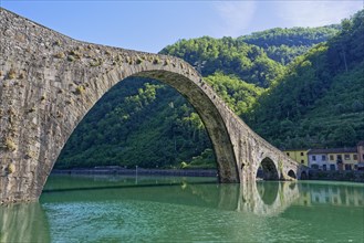 The historic Ponte della Maddalena bridge over the River Serchio in Garfagnana, Borgo a Mozzano,