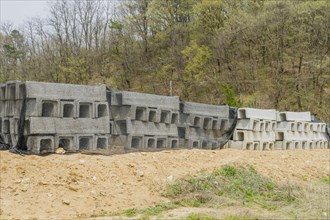 Concrete square culvert sections at base of hillside at rural construction site in Daejeon, South