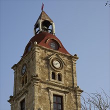Clock tower, A stone clock tower with detailed architecture and clear sky, Rhodes Old Town, Rhodes