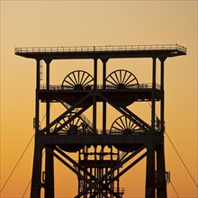 Double trestle scaffolding in front of a colourful sunrise, Gneisenau district park, Dortmund,