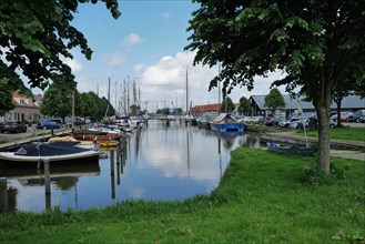 A view of sailing boats moored in water on a lovely Sping day. Monnickendam, Netherlands