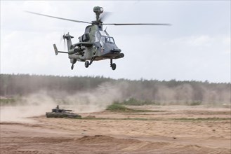 A Cougar infantry fighting vehicle and two Tiger combat helicopters, photographed during the NATO