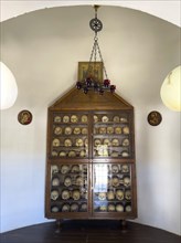 Historic ossuary with cabinet Showcase with old skulls skeletonised heads of monks from UNESCO