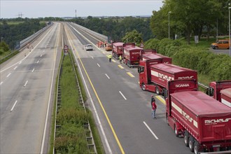 Trucks with a total weight of 960 tonnes stand on the Moselle valley bridge in Winningen during a