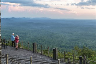 Two men watching and photographing the sunset from the Vista Cliffside Restaurant in Cheaha State