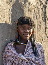 Young traditional Hakaona woman with colourful necklaces, portrait, in the morning light, Angolan