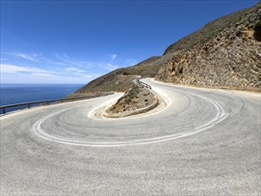 Bend of serpentines very tight 180 degree curve hairpin bend of road ascent to Passo Anopoli on