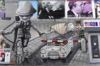 Mural depicting a checkpoint with soldiers, a car and an elaborate street scene in shades of grey,