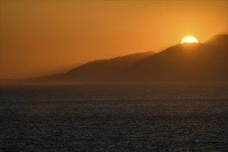 Sunset behind mountains at Gulf of Messara south coast of Crete island at Libyan Sea Mediterranean,
