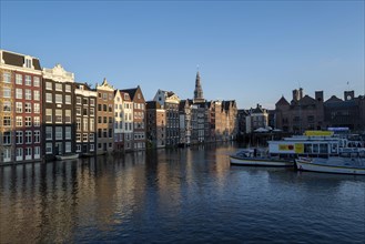 A view of Amsterdam houses by the canal in the Damark area in beautiful evening light in the month