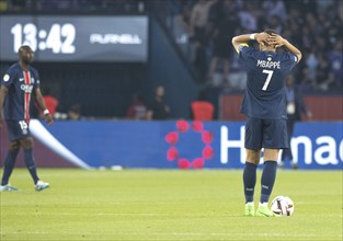 Football match, captain Kylian MBAPPE' looking from behind and holding the ball at the top of his