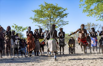 Group of traditional Hakaona woman, dancing and clapping, Angolan tribe of the Hakaona, near Opuwo,