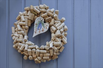 Door wreath made of wine corks with a porcelain heart on an old Tor tor, Southern Palatinate,