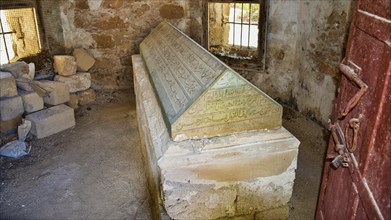 Stone sarcophagus, Admiral Murat Reis, Historic tombstone with inscriptions in an abandoned