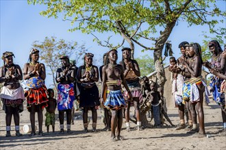 Group of traditional Hakaona woman and men, dancing and clapping, Angolan tribe of the Hakaona,