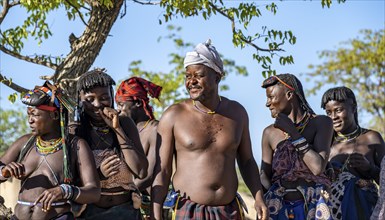 Hakaona man and traditional woman laughing, Angolan tribe of the Hakaona, near Opuwo, Kunene,