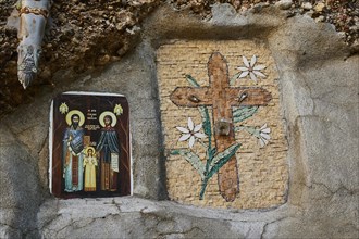 Rock Chapel, Archangel Michael Panormitits, Two religious mosaics on one wall, one shows a cross
