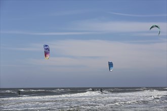 Kite surfers enjoy the waves on a glorious day along the Dutch coast. Castricum, Netherlands