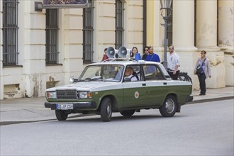 A Lada of the former GDR People's Police drives past the Dresden Police Headquarters, Dresden,
