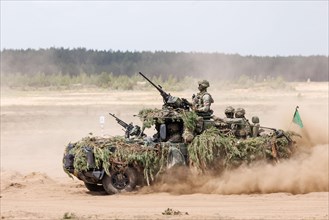 Dutch soldiers on a camouflaged Serval during the NATO Steadfast Defender large-scale manoeuvre in