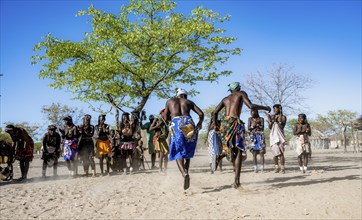 Group of Hakaona woman and men, dancing and clapping, Angolan tribe of the Hakaona, near Opuwo,