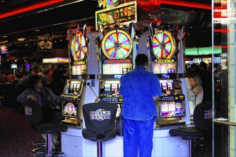 Las Vegas, Nevada, USA, North America, People playing slot machines in a busy casino, Las Vegas